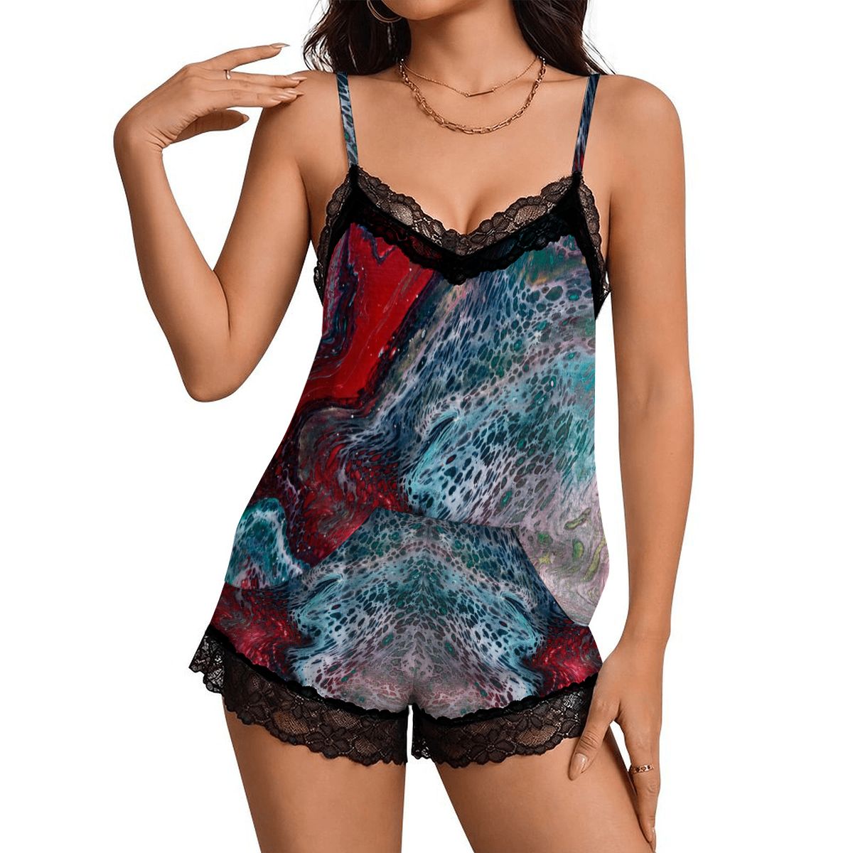 A woman models a short camisole romper with a colorful abstract print in red, teal, and gray, featuring black lace trim at the neckline and hem a Style by Jess at Gotta Have It Design 