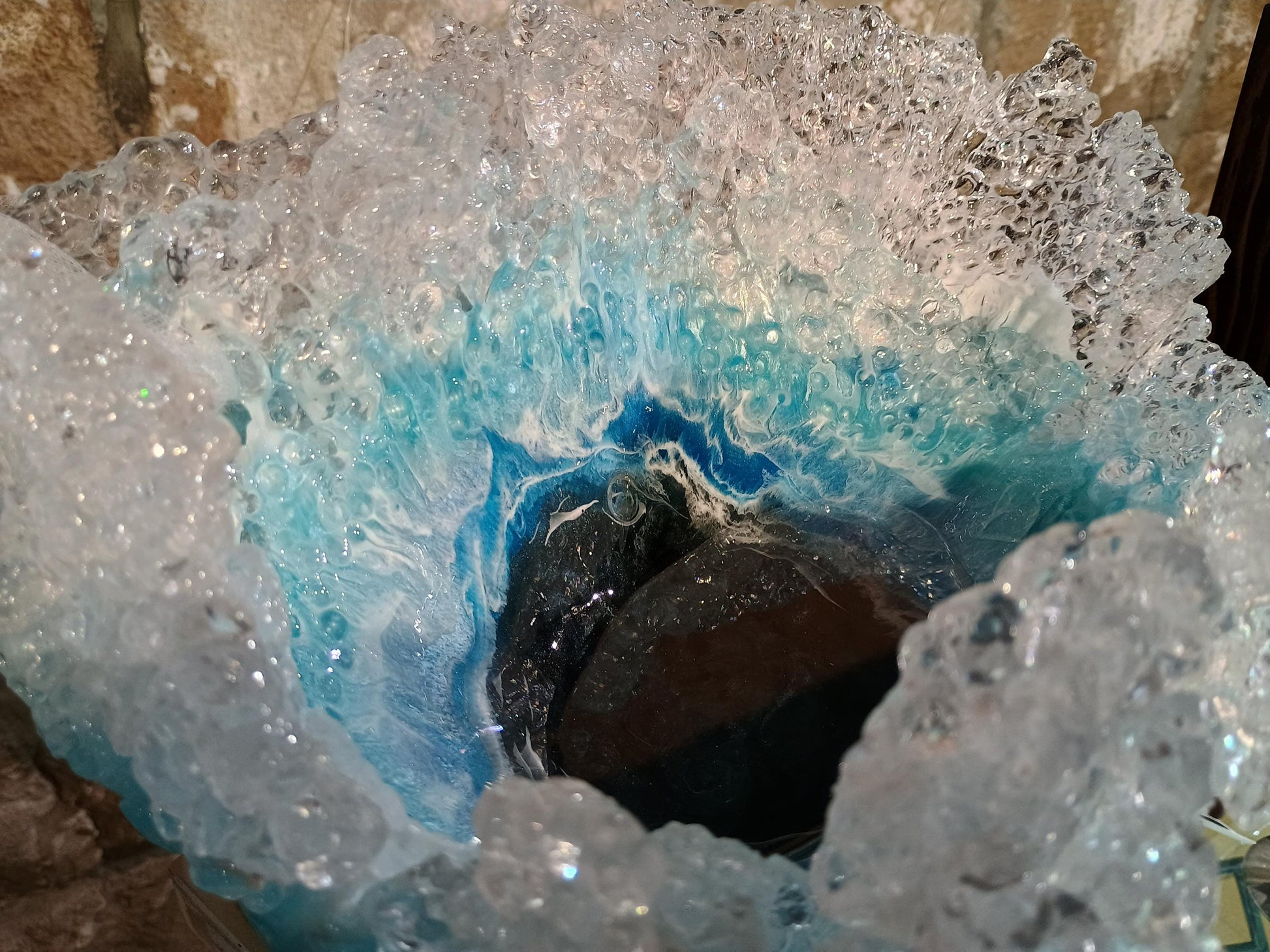 Close-up of a ocean resin bowl with a blue interior and crystal-like exterior.