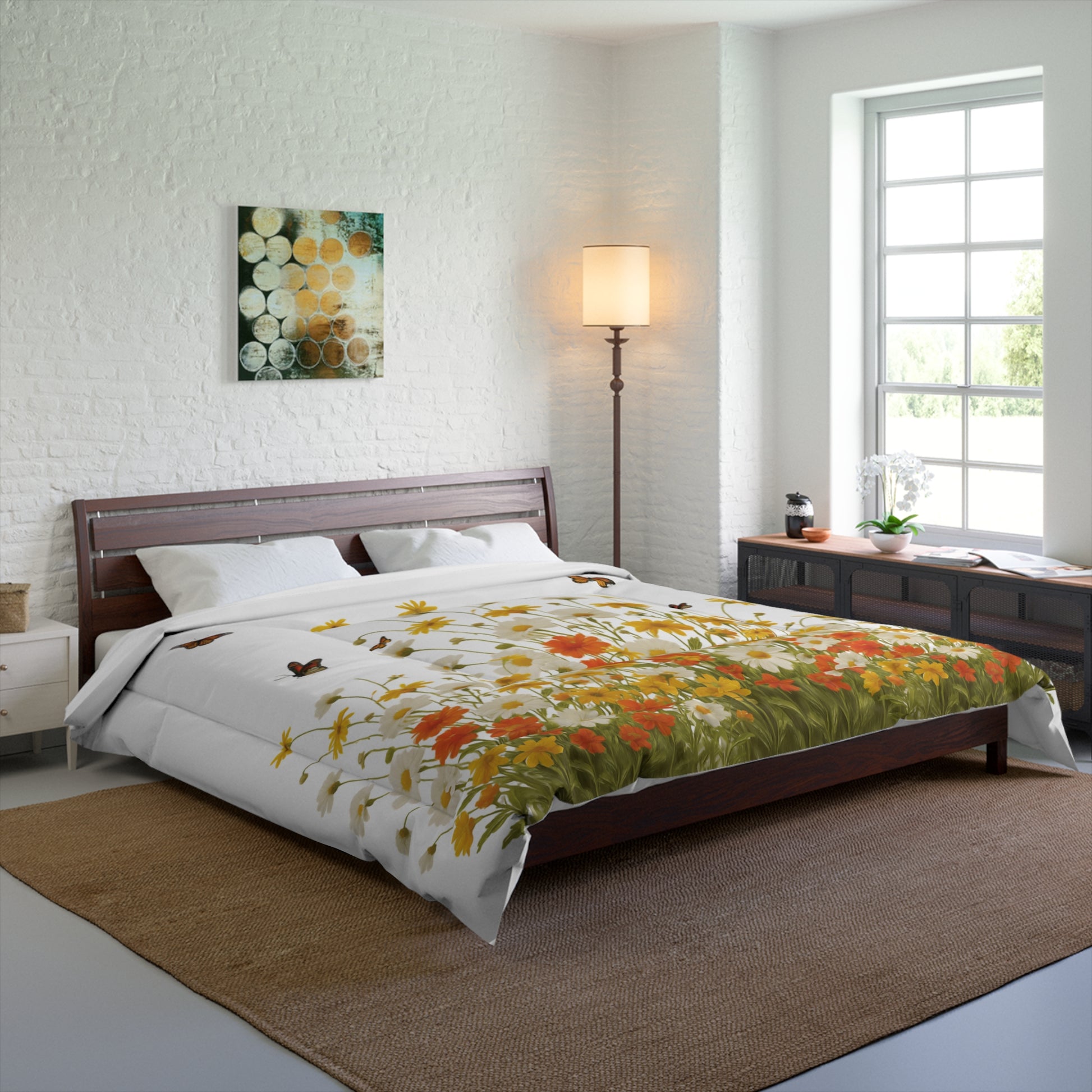 Bedroom with floral comforter on bed, lamp, and artwork on wall.