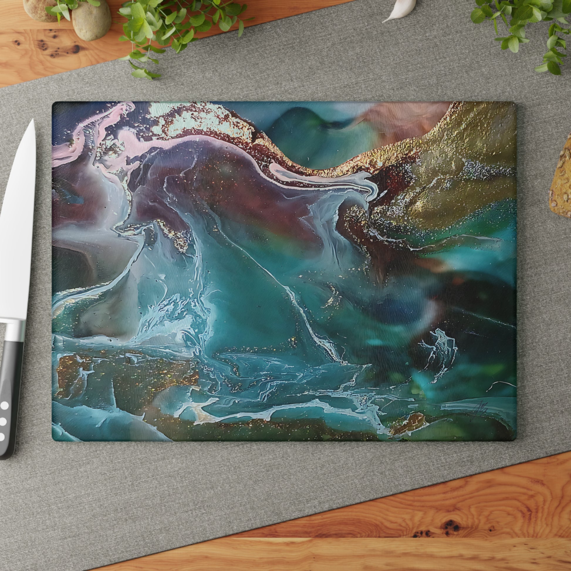 Abstract art cutting board on a place mat on a wood table.