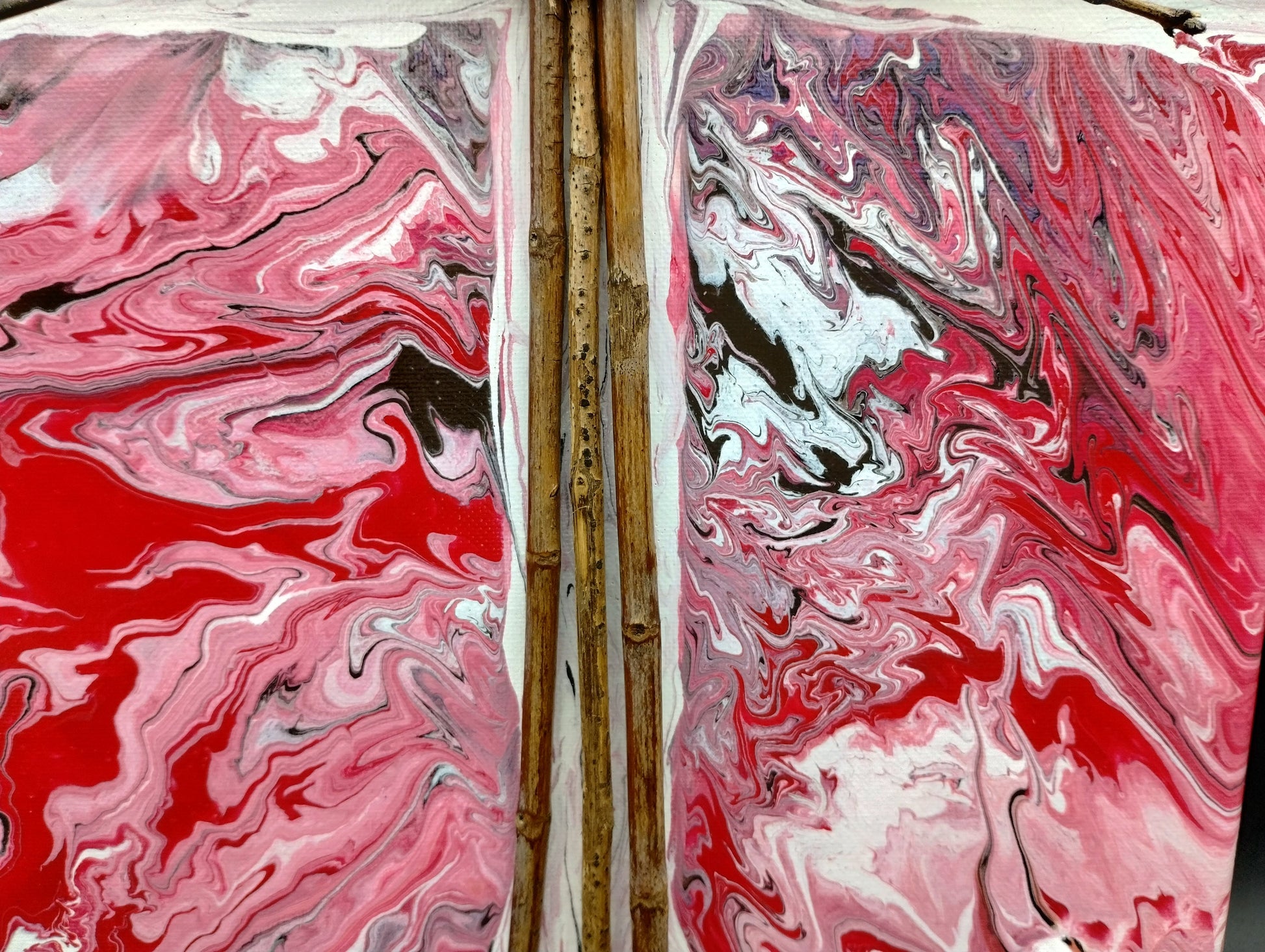 Artistic marbled design with red, white, and black on a textured surface.