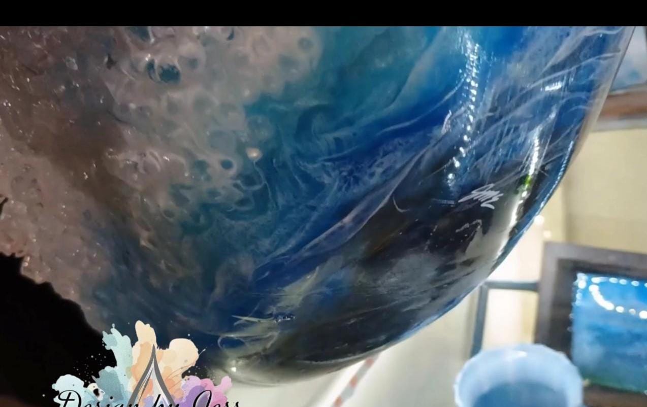 Close-up of a blue and gray marbled lower surface of the bowl with a blurred background