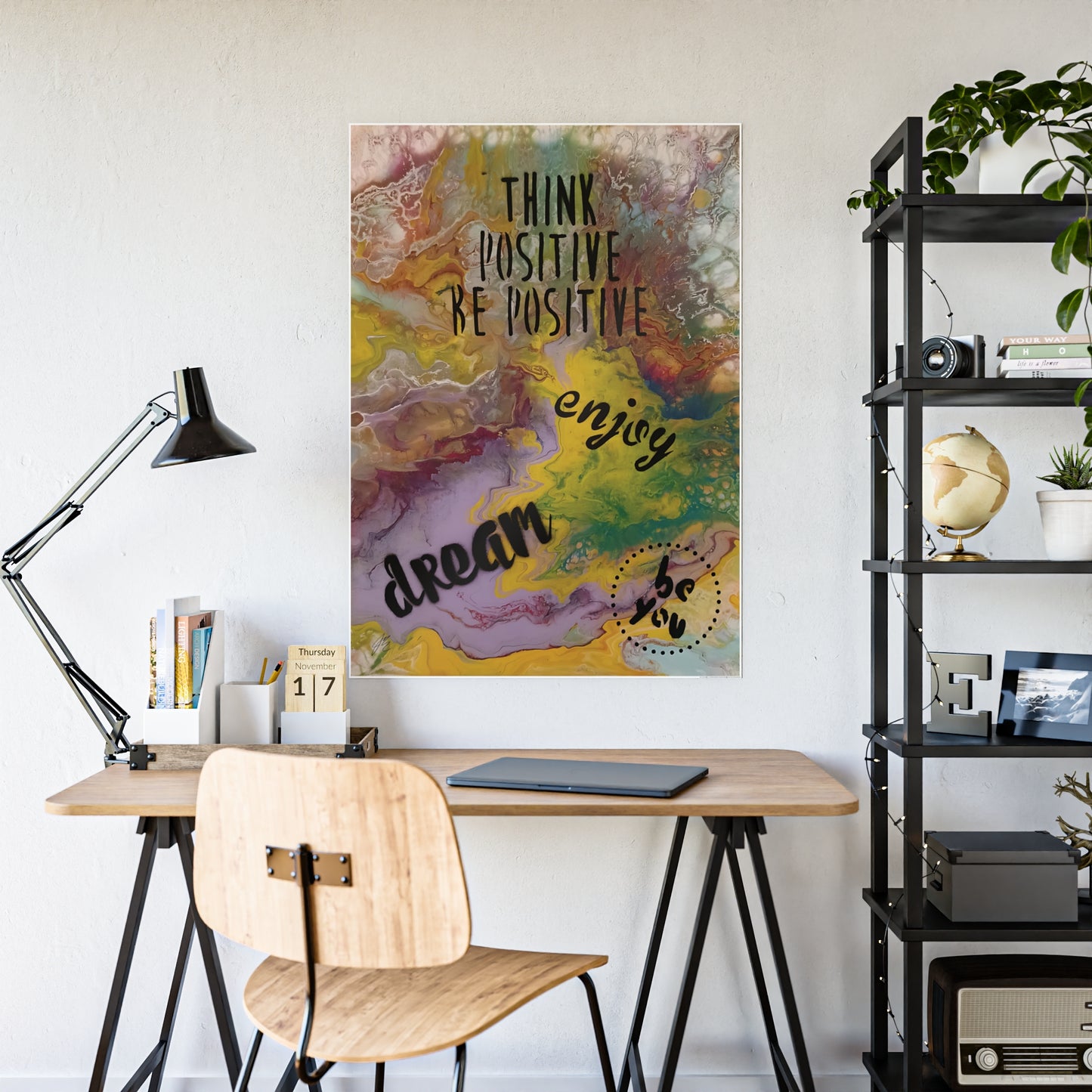 Home office with a desk, chair, and motivational poster on the wall.