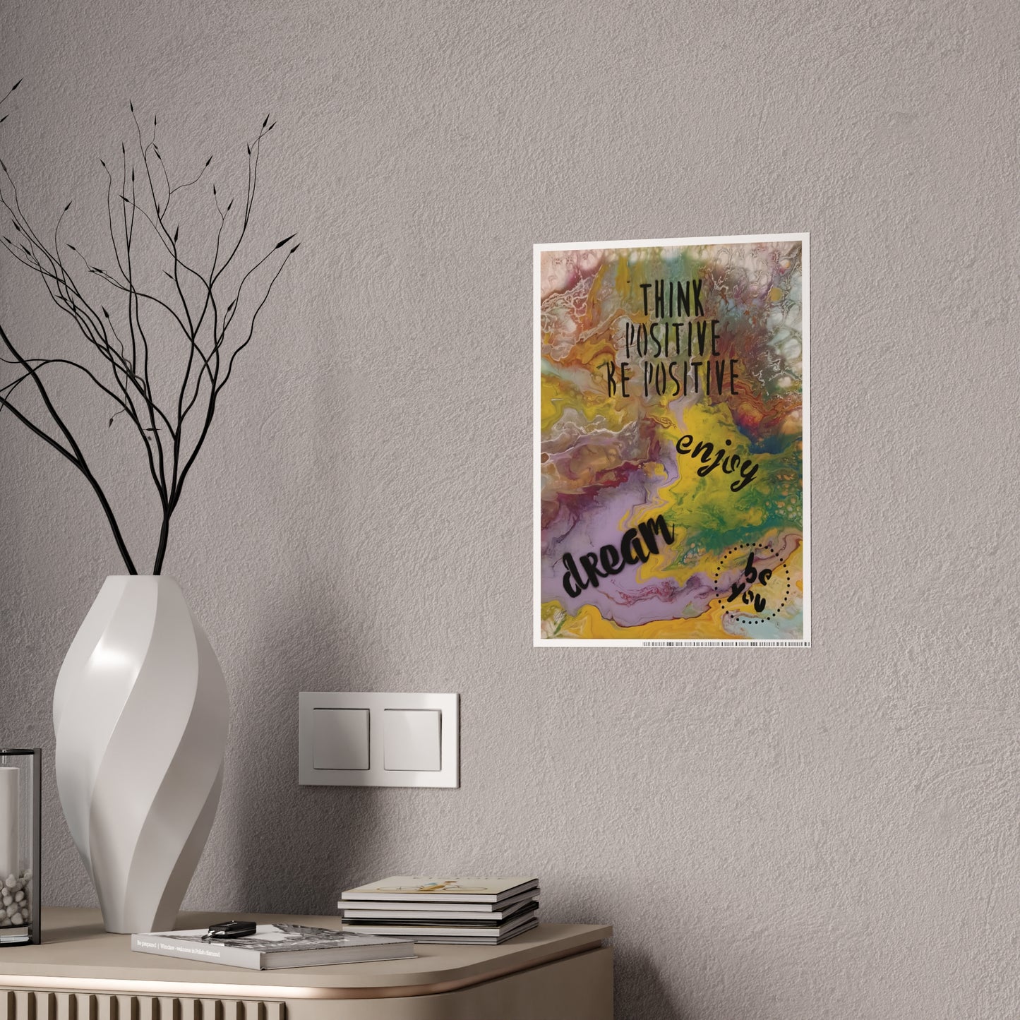 Colorful motivational poster on a wall above a table with decor items.