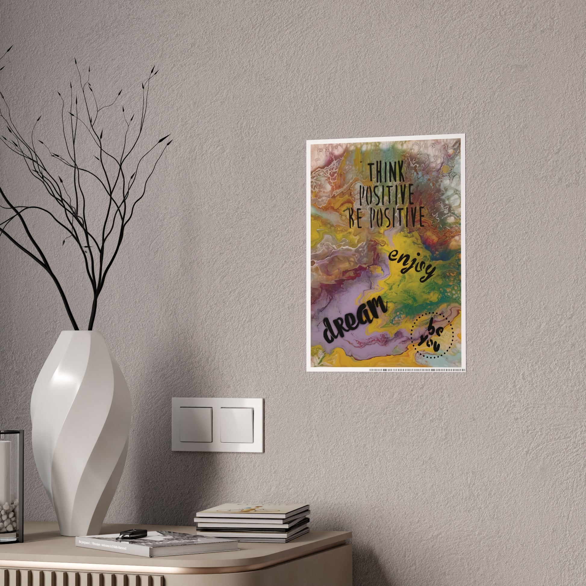 Colorful motivational poster on a wall above a table with decor items.