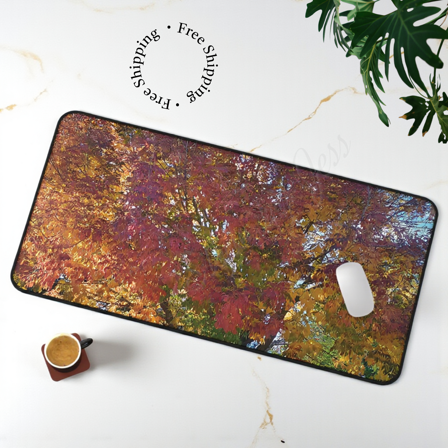 Colorful abstract mouse pad with a cup and plant on a white surface home office decor accessories.