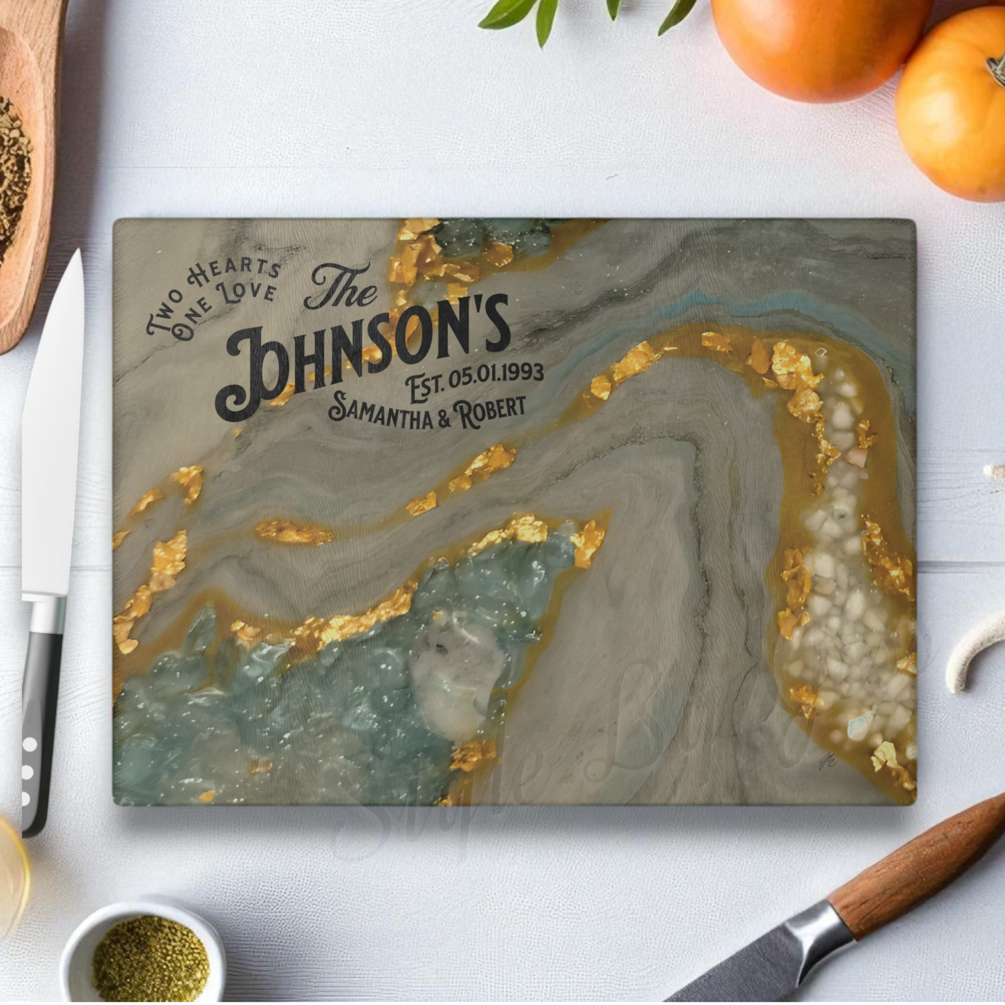 Personalized cutting board with gold and gray design on a kitchen counter. Style by Jess