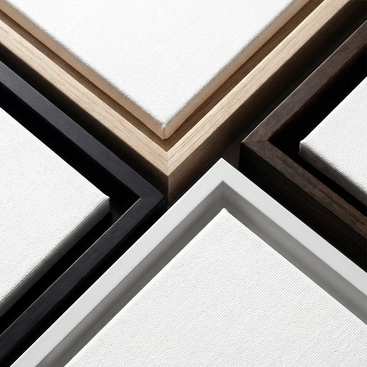 Close-up of various wooden picture frames on a white background