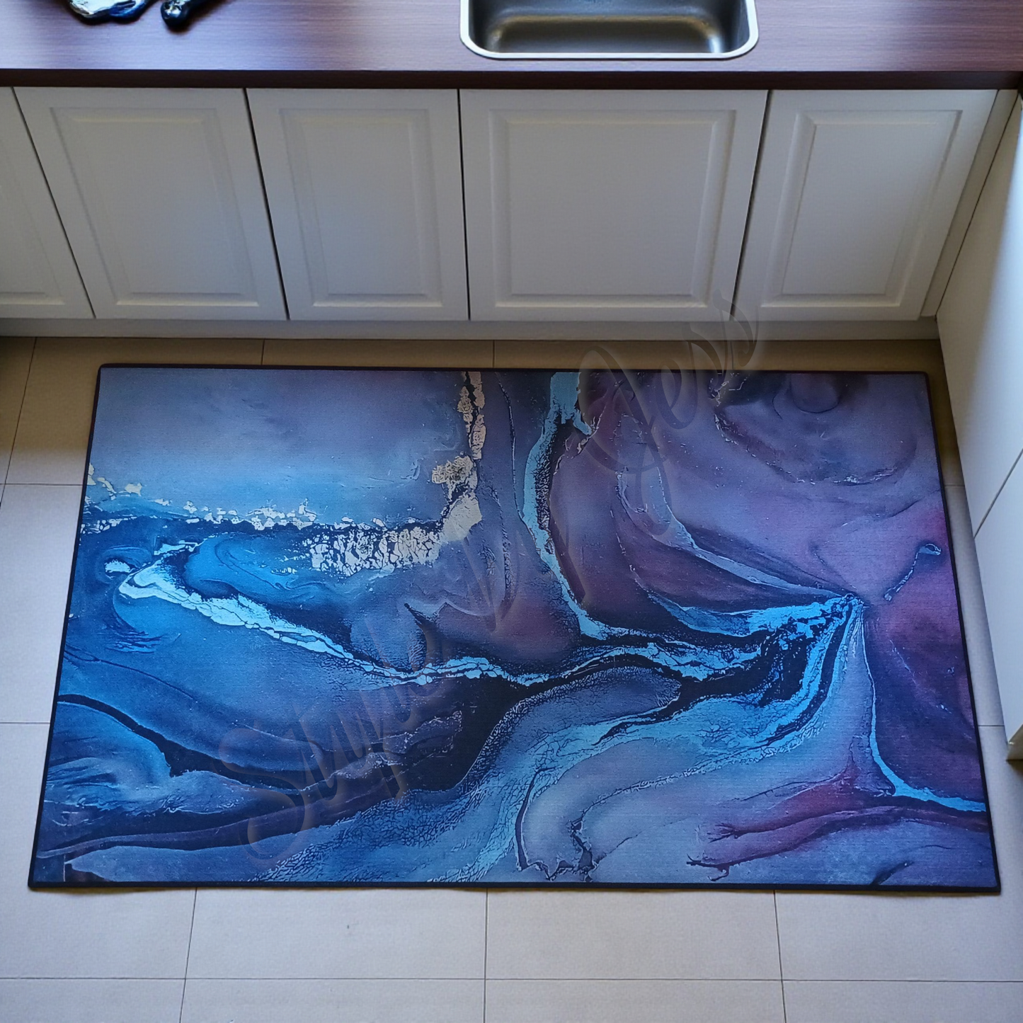 Abstract design rug on a kitchen floor with cabinets and a sink in the background