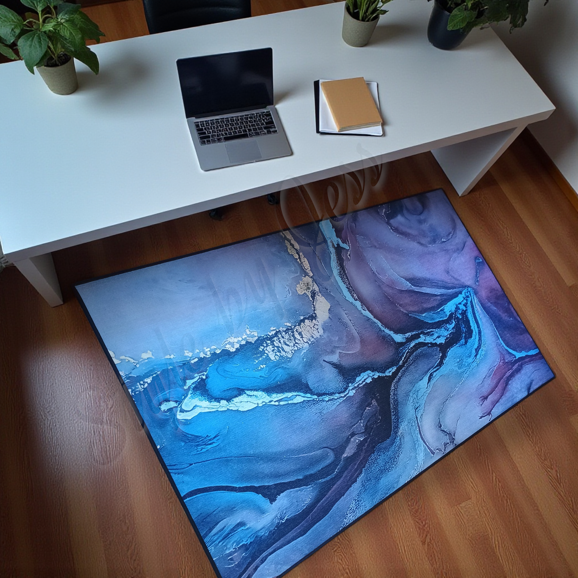 Abstract blue a rug on a wooden floor with a white desk and laptop in the background.