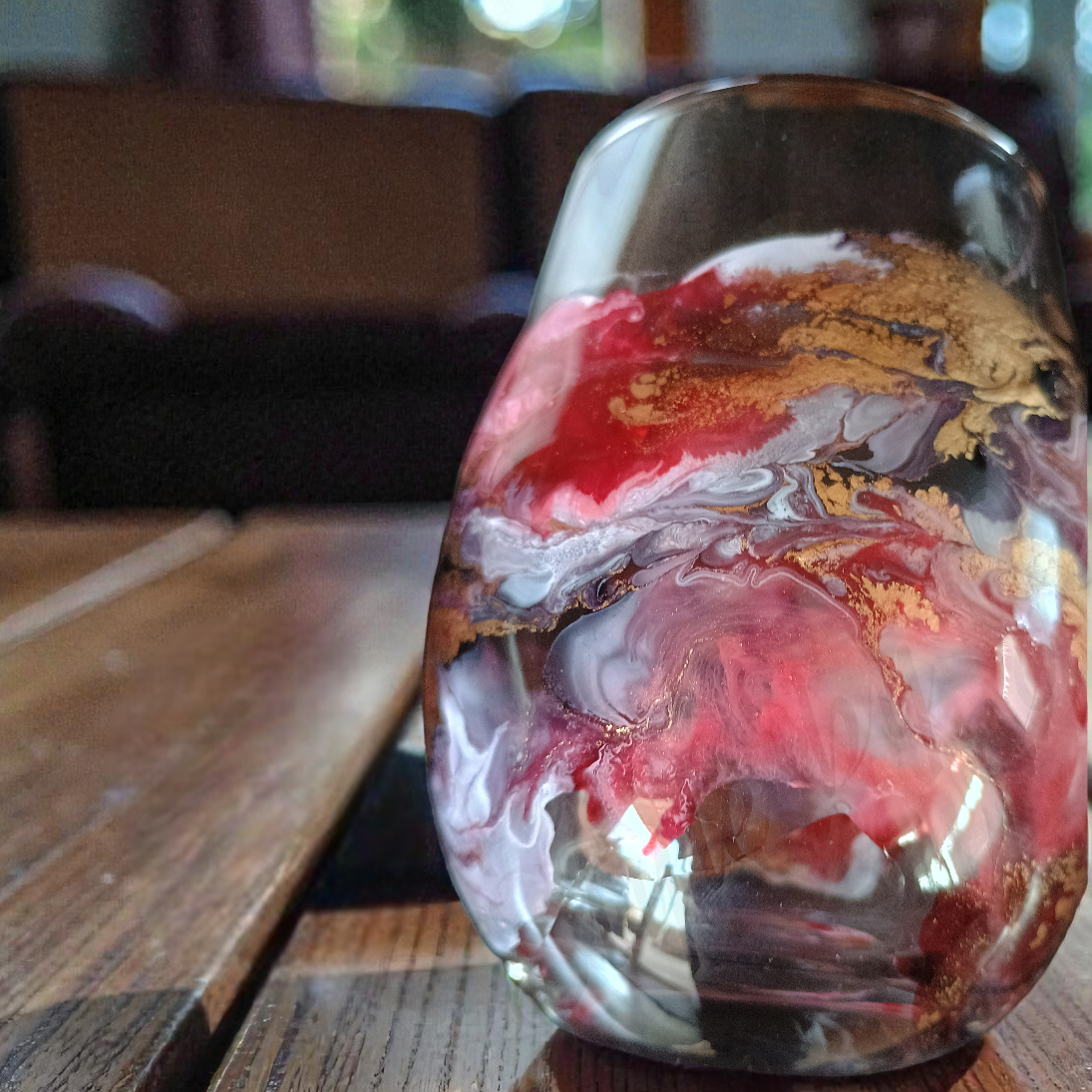 Glass vase with marbled design on a wooden table