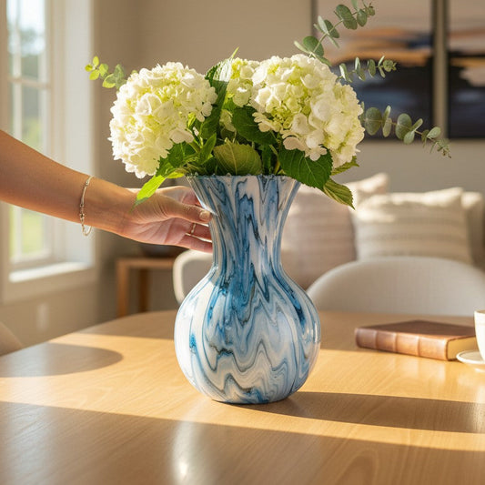Blue marbled vase with white flowers on a wooden table as a centerpiece in a living room a Style By Jess at Gotta Have It Design. 