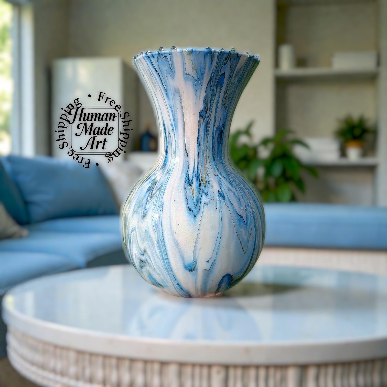 Blue and white marbled vase on a table with a blurred living room background human made art and free shipping