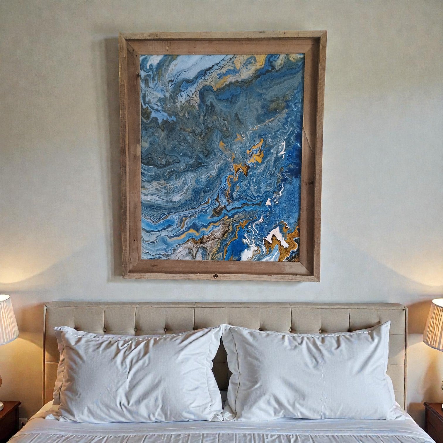 Bedroom decor with a blue abstract painting above the bed and a minimalist styel. 