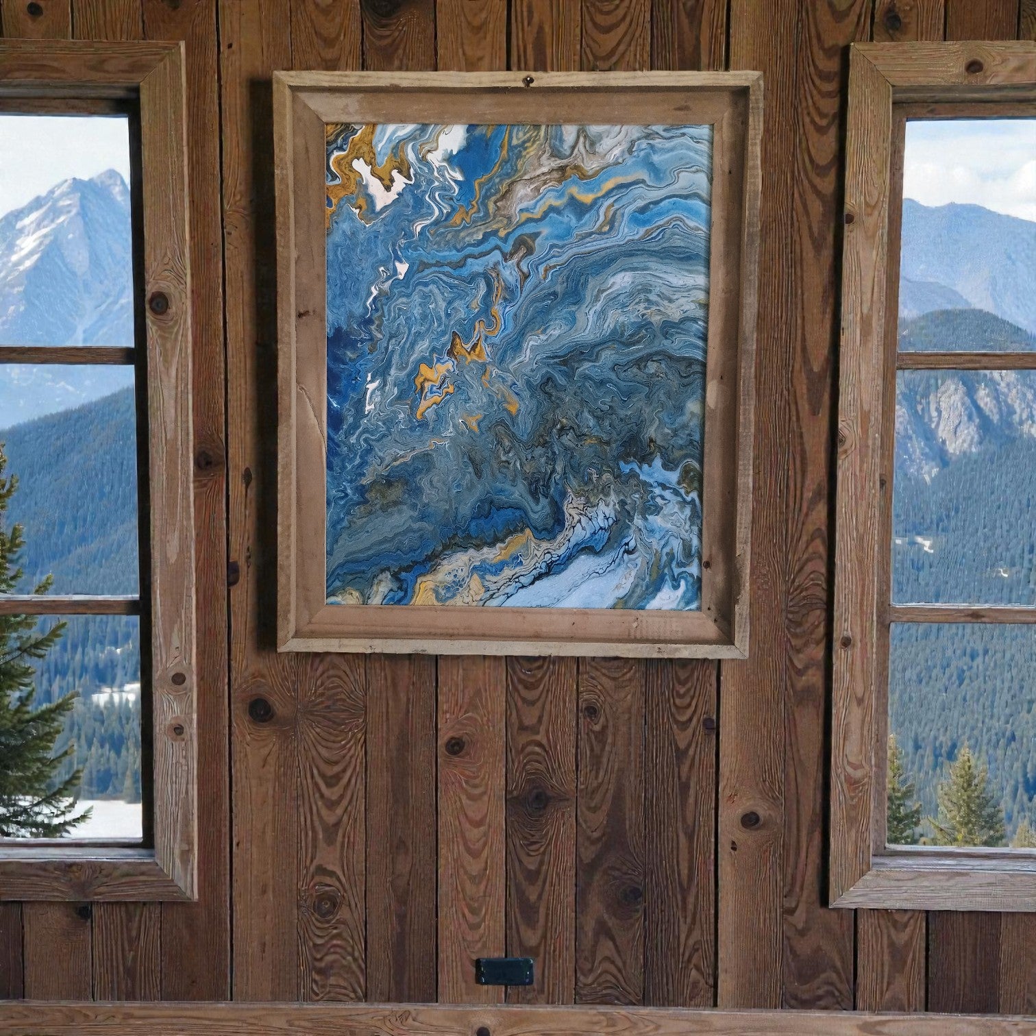 Framed abstract painting on a wooden wall with mountain views through windows a Colorado Original Artist piece a Style By Jess at Gotta Have It Design 