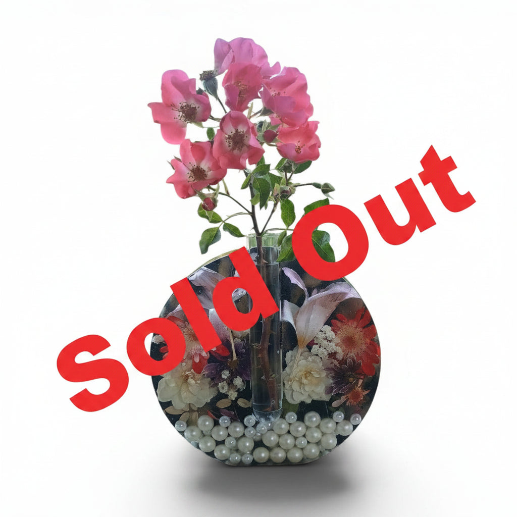 Handmade dried flower resin vase with garden-grown roses, daisies, and lilies embedded in black and gold resin, pearl bottom, with propagation tube bud vase insert