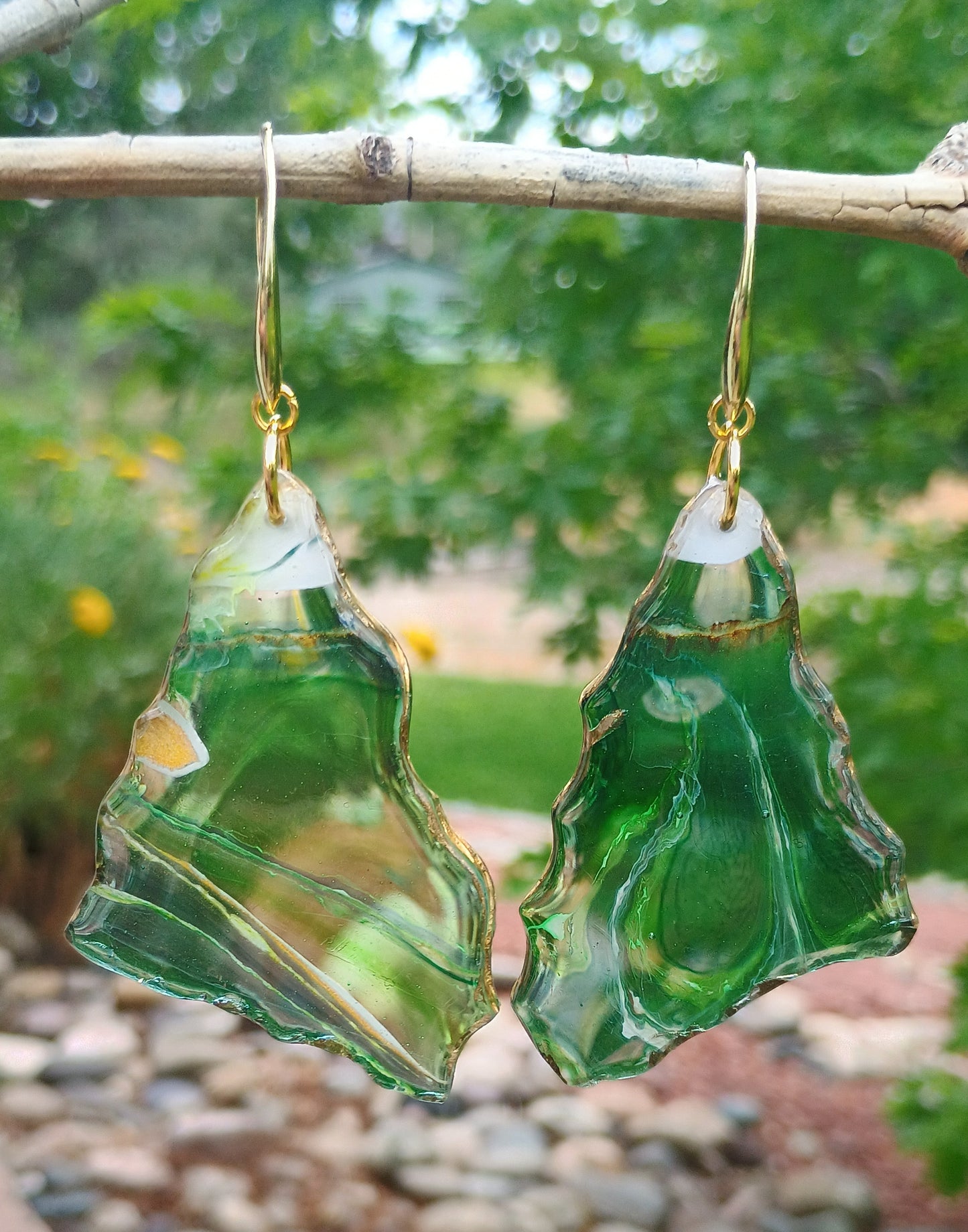 One of a kind green geode style statement earrings with with a white peak and 18K Gold Plated earring hooks hanging on a branch with a natural background a Stye By Jess at Gotta Have It Design.