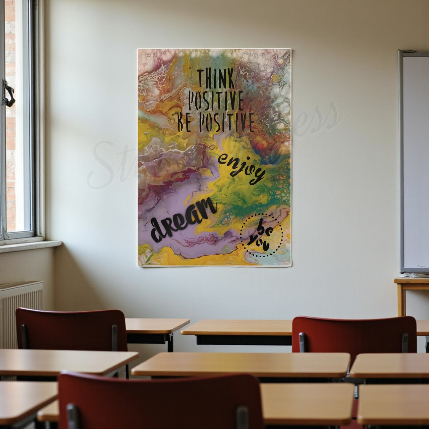 Colorful motivational poster on a wall in a classroom with desks and chairs.