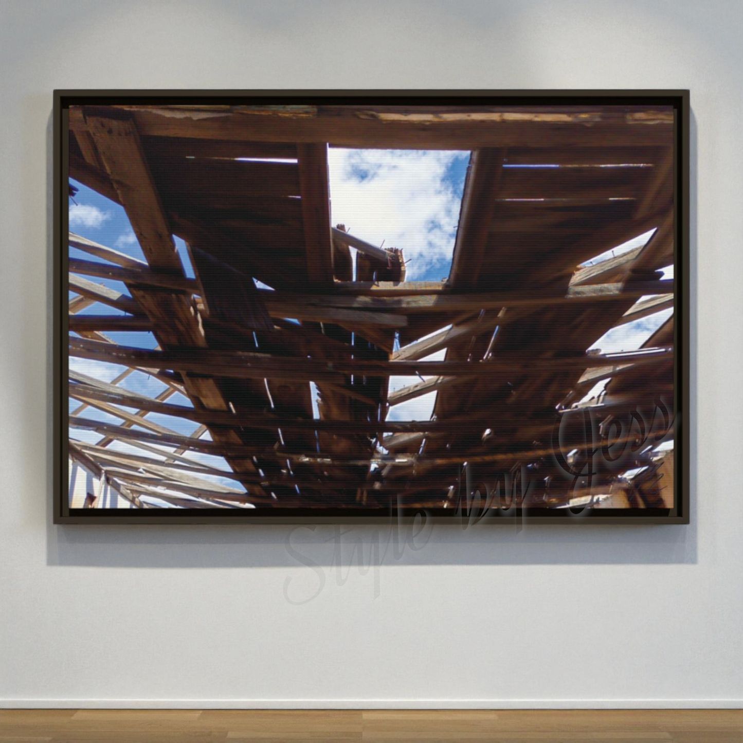 Framed artwork of a wooden structure with a blue sky reflection on a white wall. Style By Jess at Gotta Have It Design