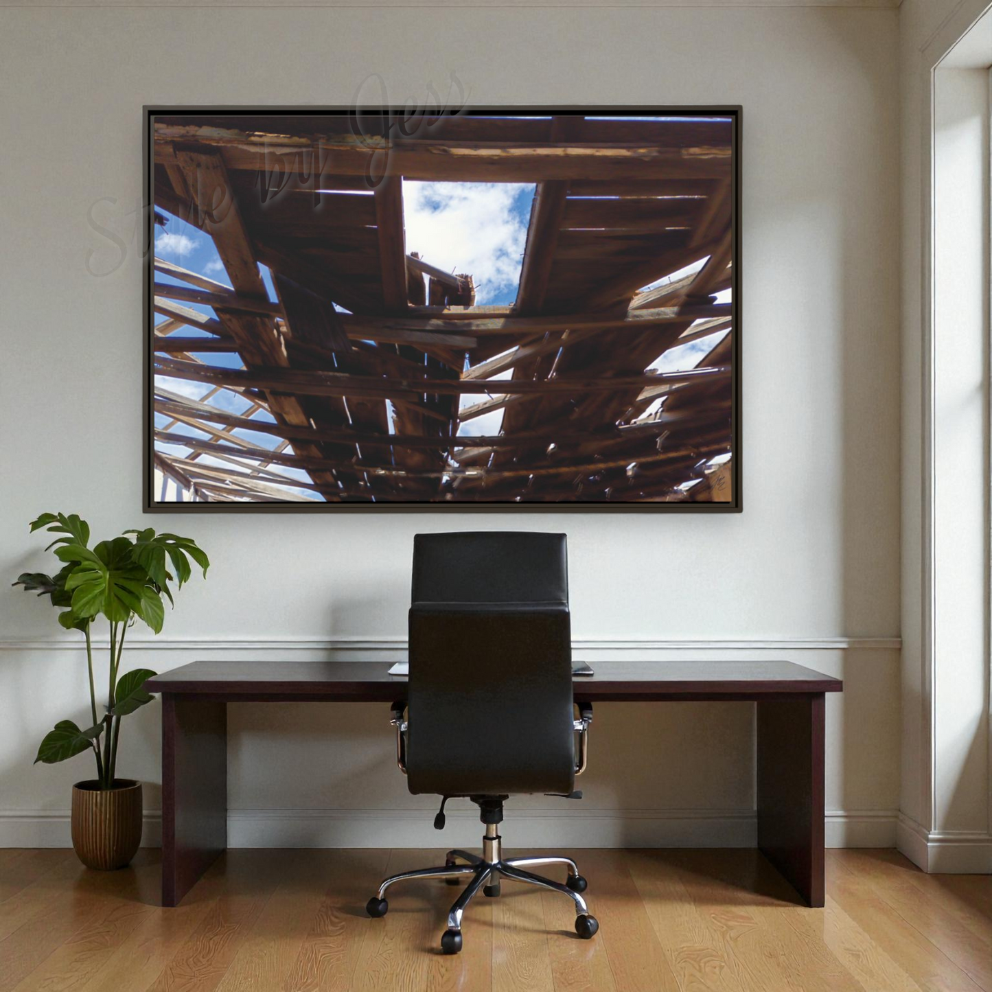 Modern office setup with a large wall-mounted artwork, desk, and chair.