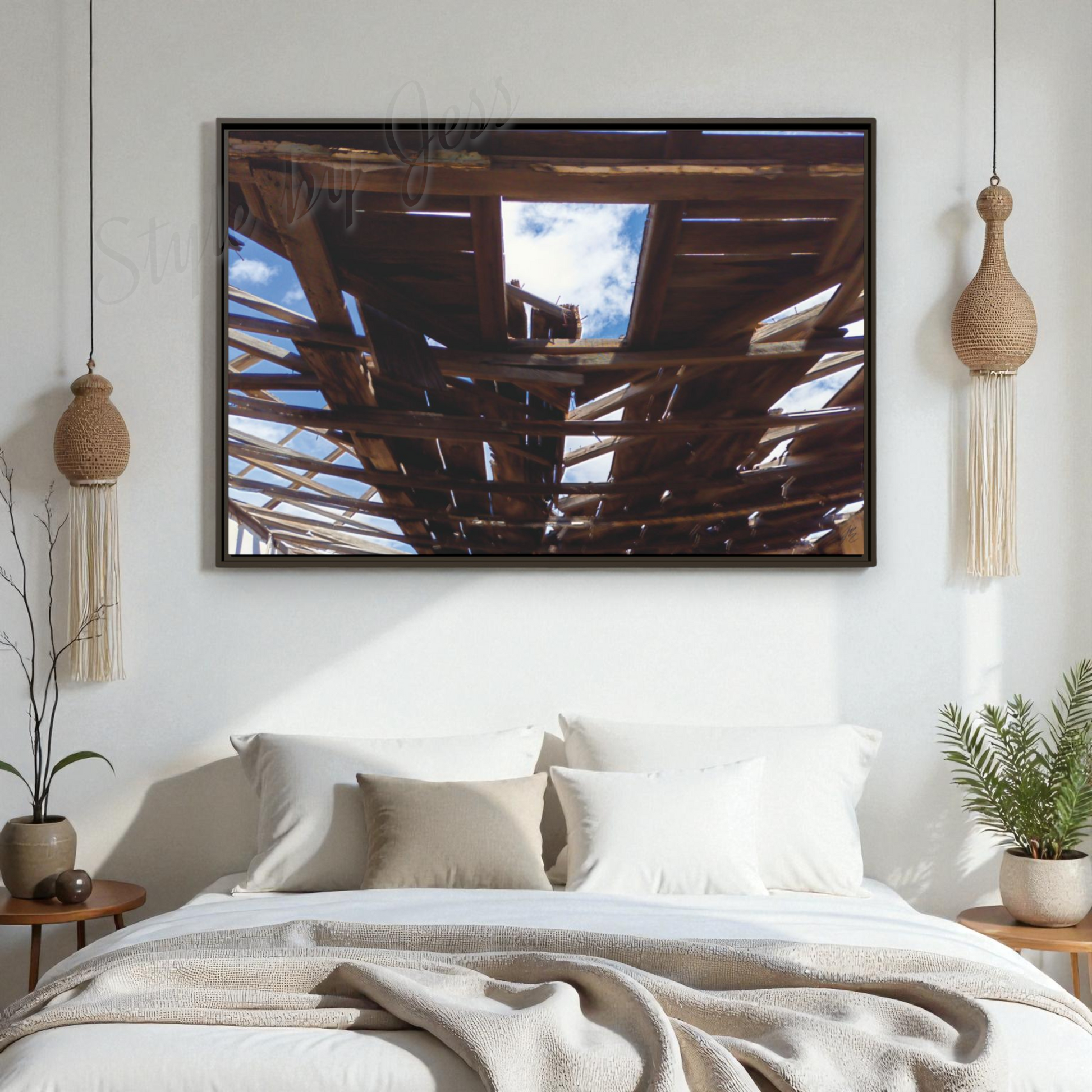 Bedroom with a large framed picture on the wall above a bed.