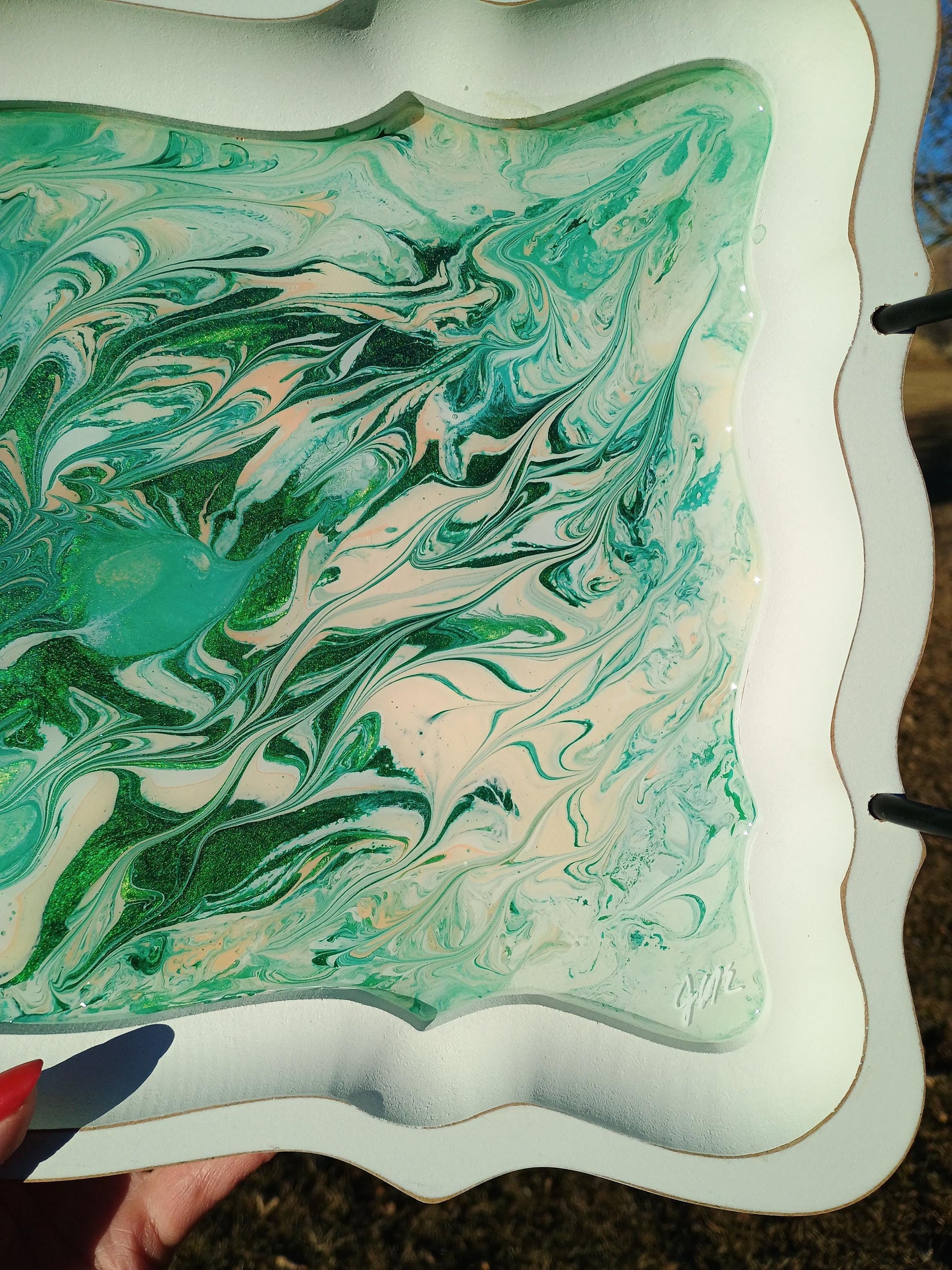 Marbled green and white surface on a decorative tray