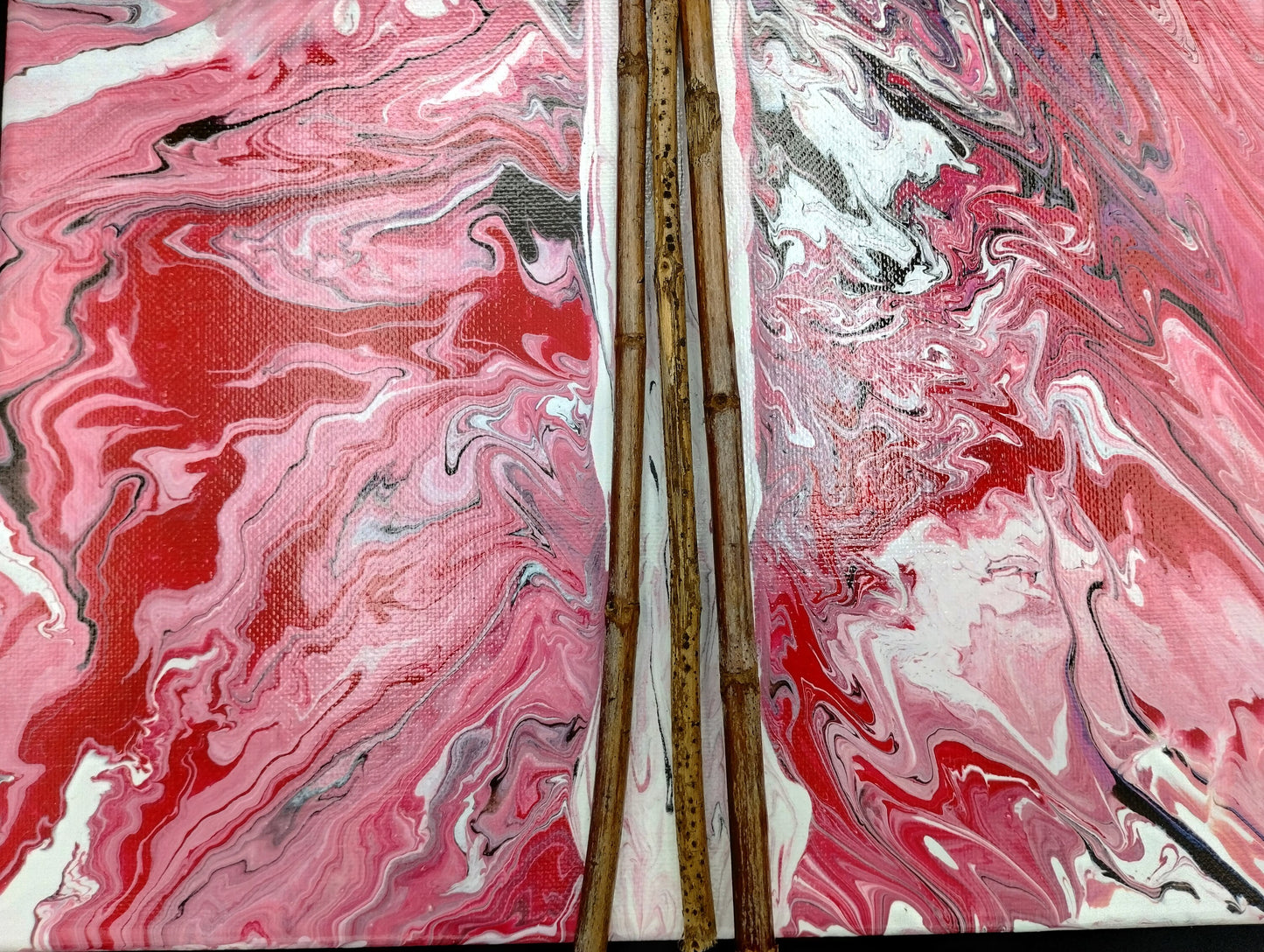 Marbled pink and red surface with a close up of the maple wood that makes the cross.