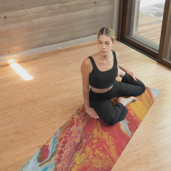 Video of woman sitting on a yoga mat exercising on a hardwood floor.  Style by Jess