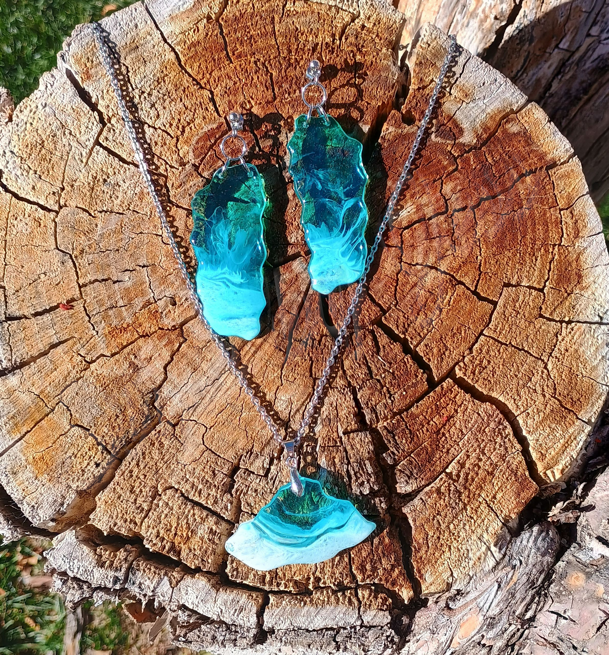 Turquoise resin dangle earrings and beach necklace on a wooden surface a Style by Jess at Gotta Have It Design