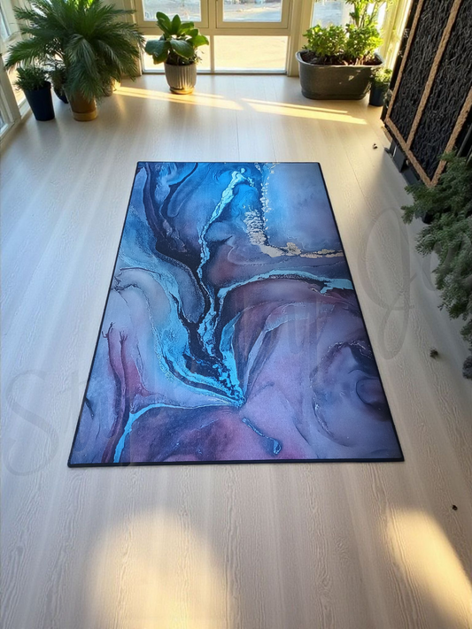 Abstract blue and blush rug on a light wooden floor with plants around Style by Jess at Gotta Have It Design