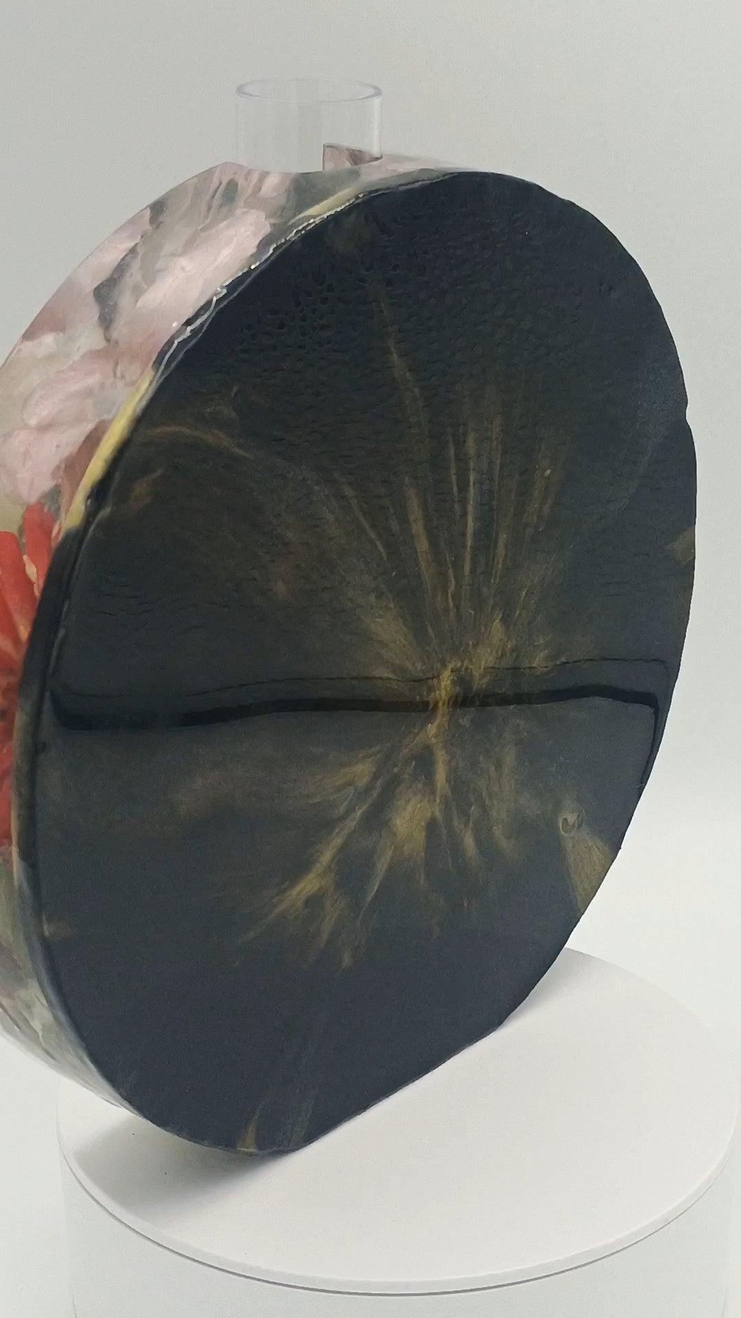 Back and gold back of resin flower vase that is two sided. 