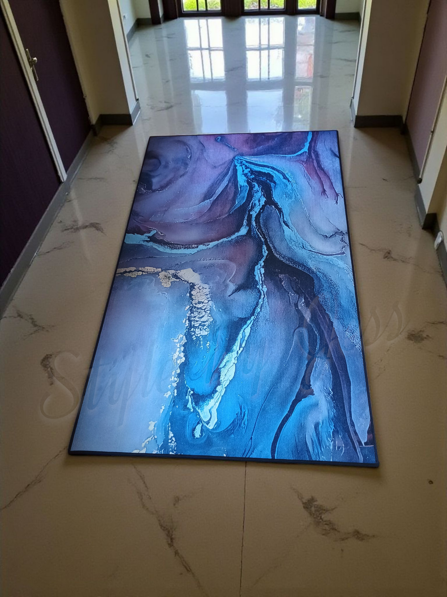 Abstract blue entry rug on a marble floor