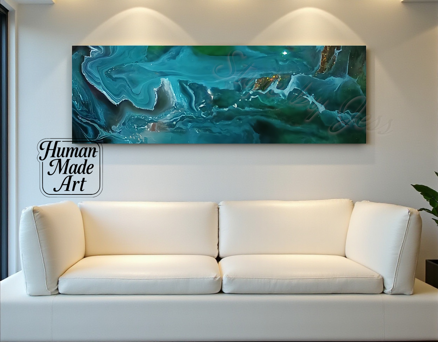 White sofa in front of a large abstract painting on a wall with 'Human Made Art' sign a Style By Jess.