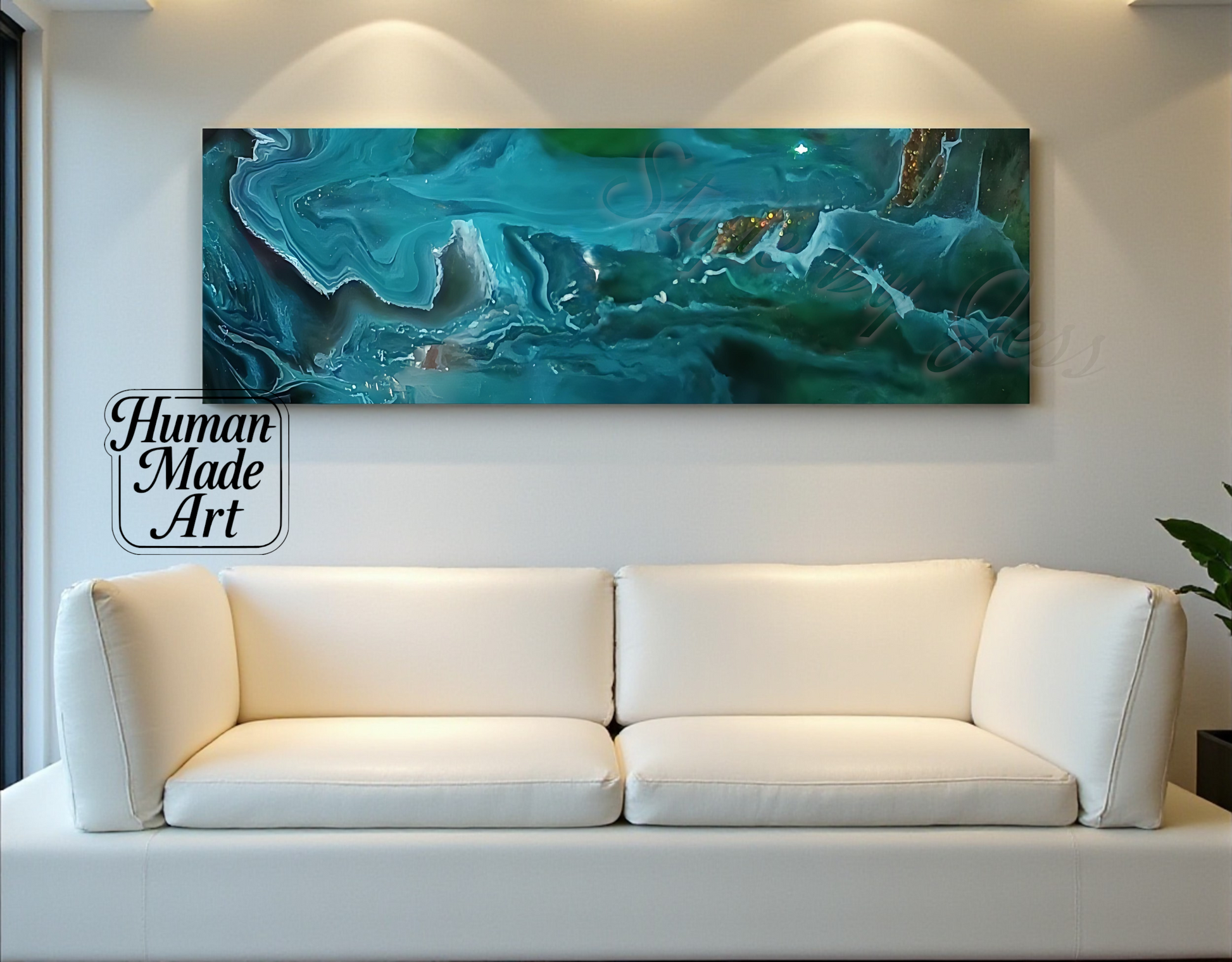 White sofa in front of a large abstract painting on a wall with 'Human Made Art' sign a Style By Jess.