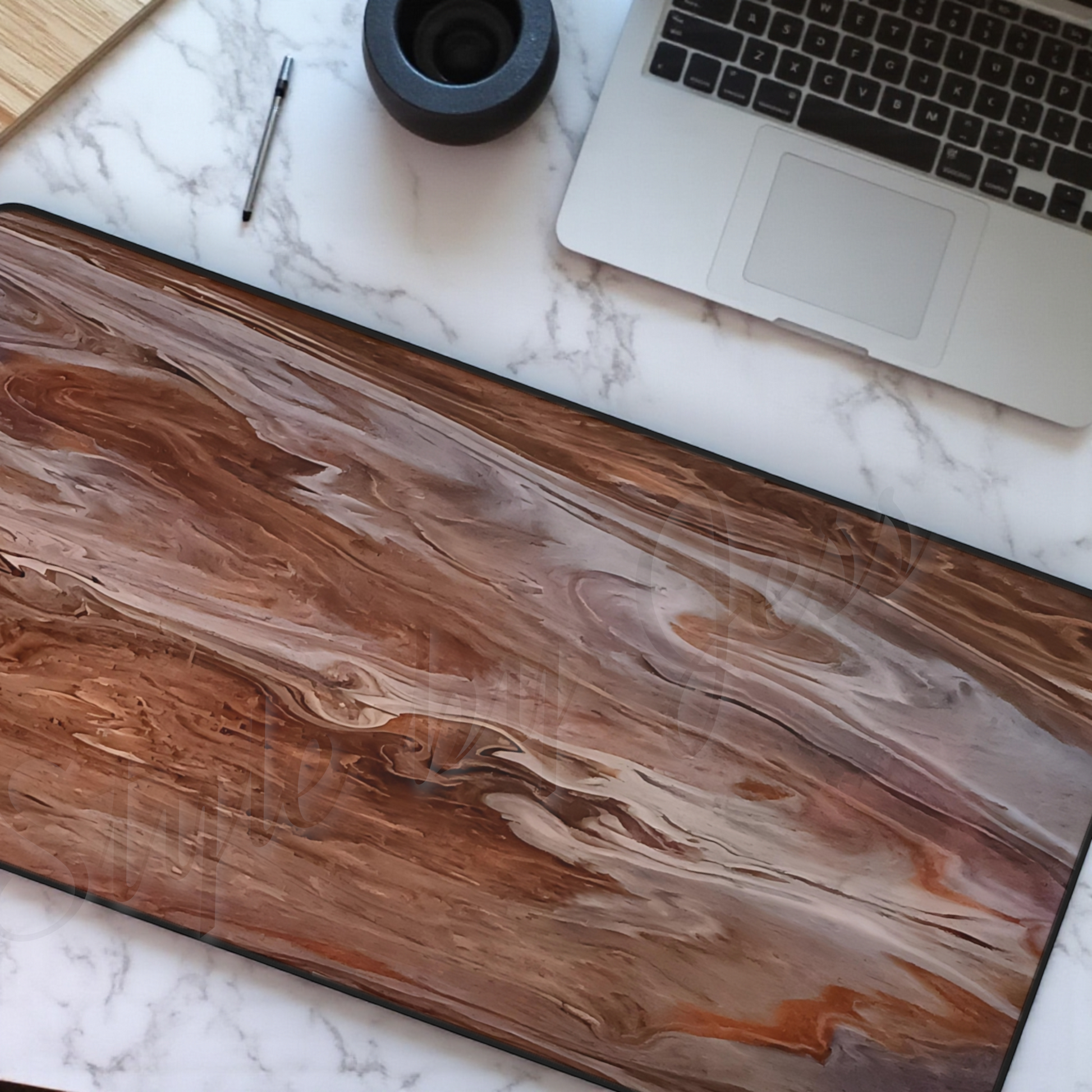 Wood looking desk pad with laptop, pen, and small container on marble surface