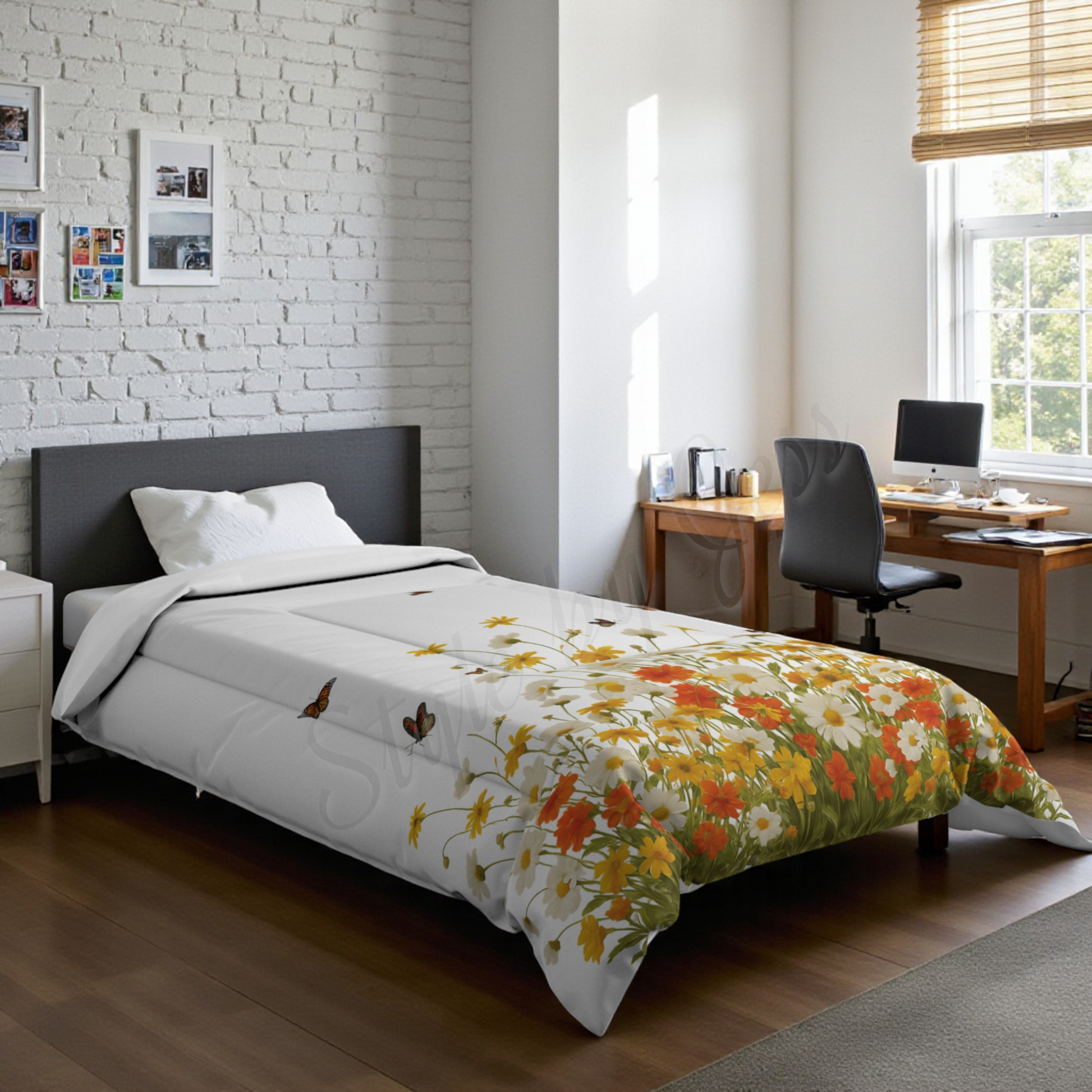 Bedroom with a bed featuring a twin  size floral comforter and a desk area in a dorm room setting. 