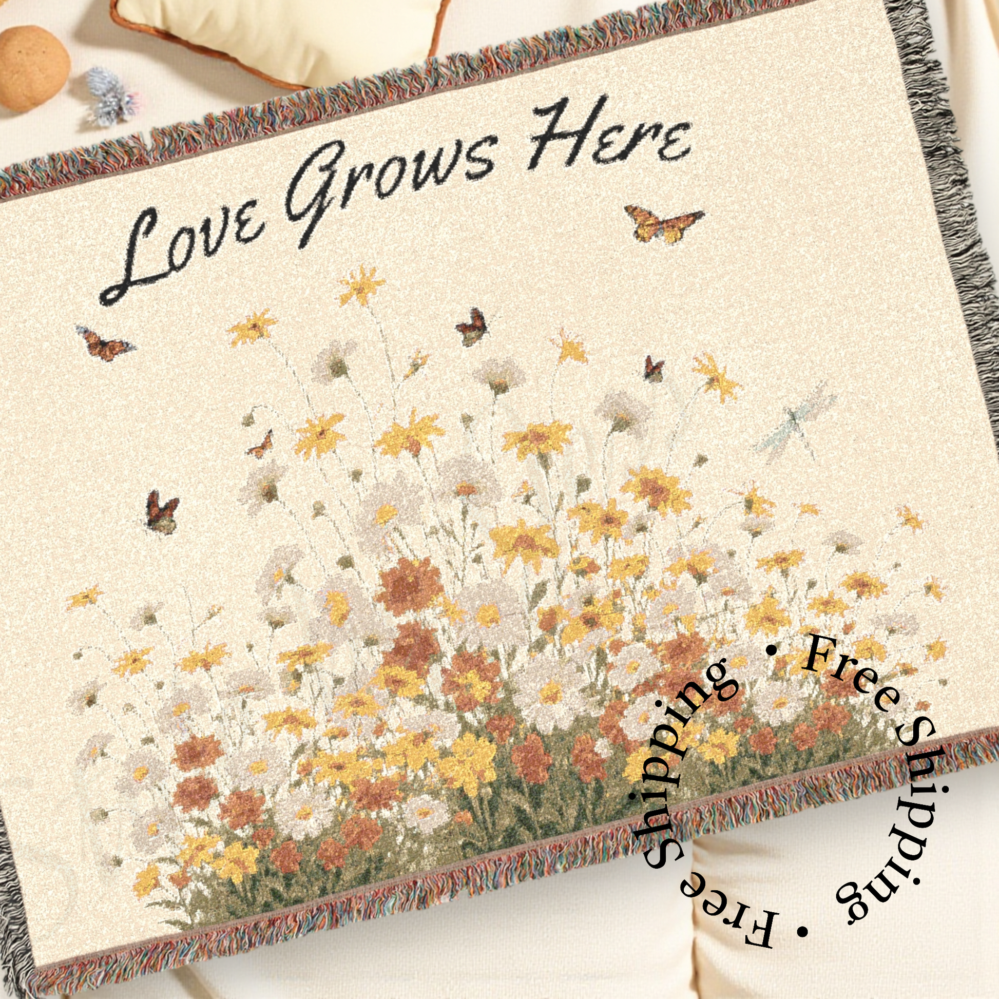 Blanket with floral design and 'Love Grows Here' text on a white surface a Style By Jess at Gotta Have It Design