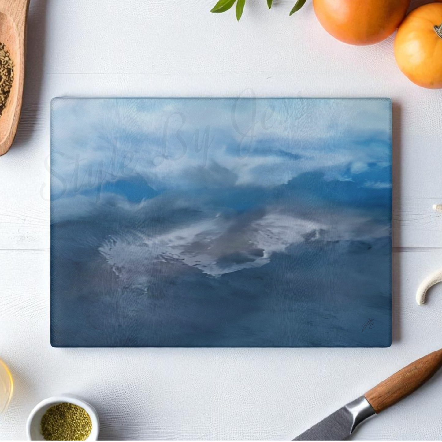 Glass cutting board with mountain design on a kitchen counter