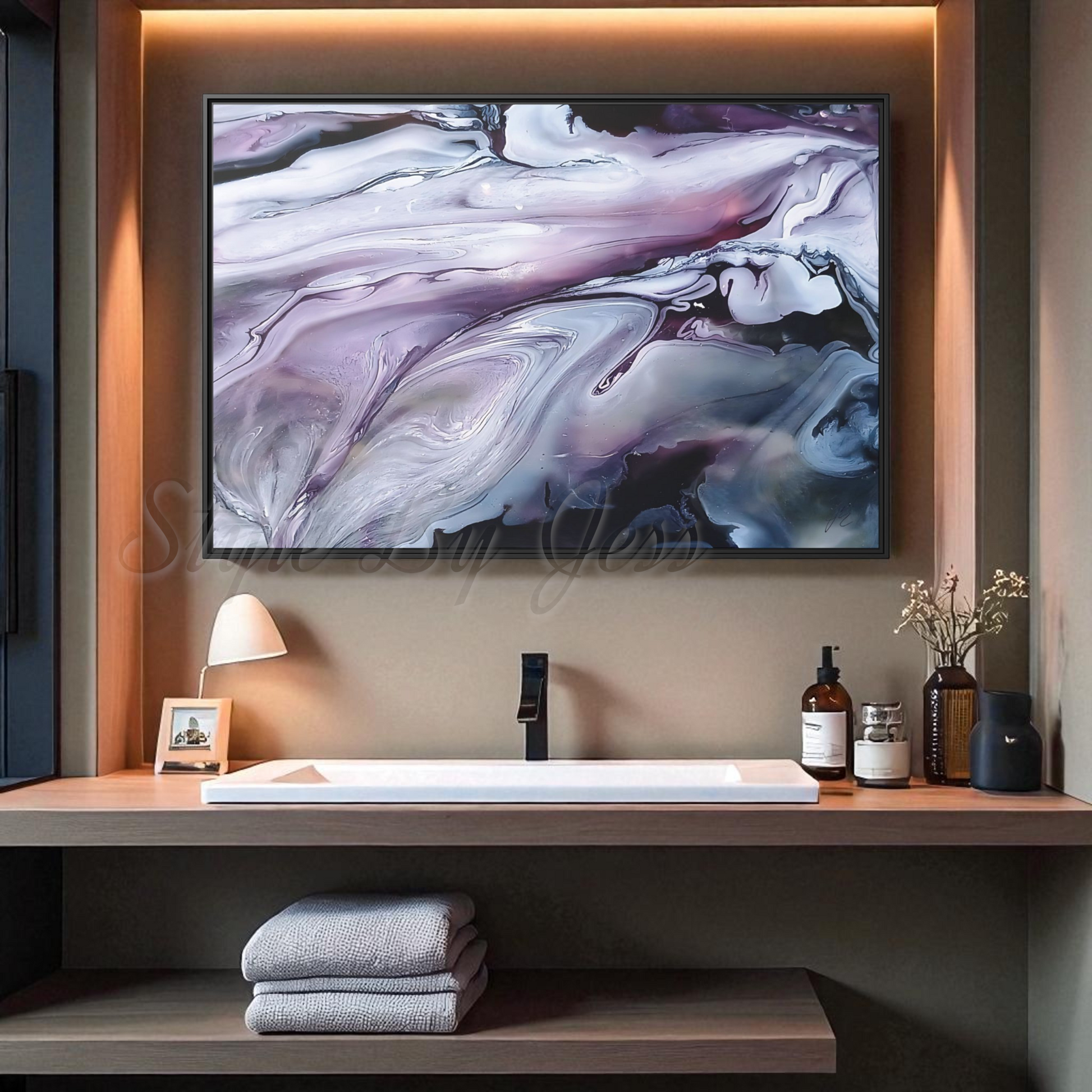 Modern bathroom setup with a sink, towels, and decorative items on a shelf below an abstract painting by Style By Jess.