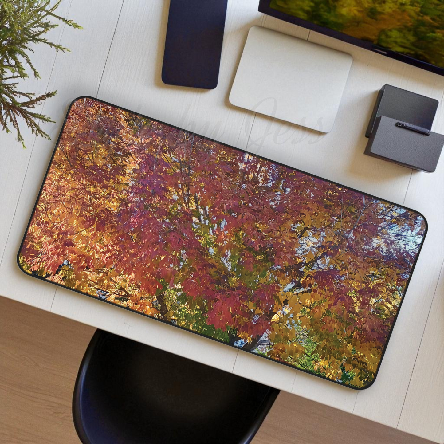 Colorful abstract desk mat on a desk with office items boss gift idea.